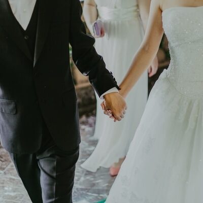 married couple walking down aisle