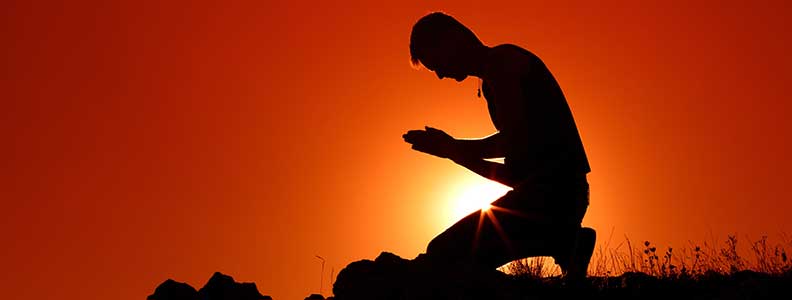 Man kneeling down and praying