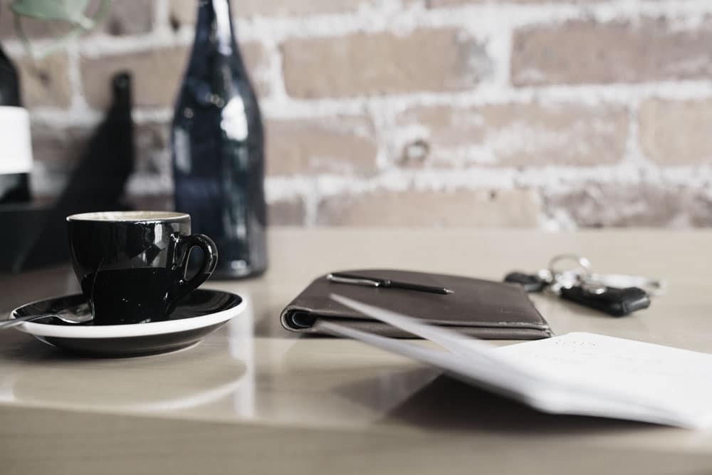coffee cup and notebook on table