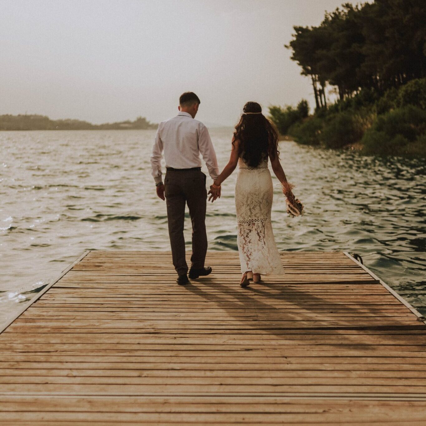 wedding couple walking on pier