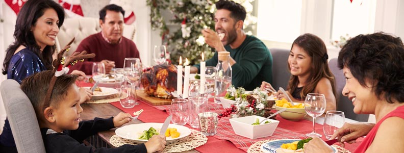 Multi-generational family eating Christmas dinner